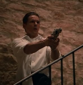 Ethan Hawke holding a Raging Judge revolver in The Purge