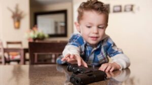 image of a Child reaching gun