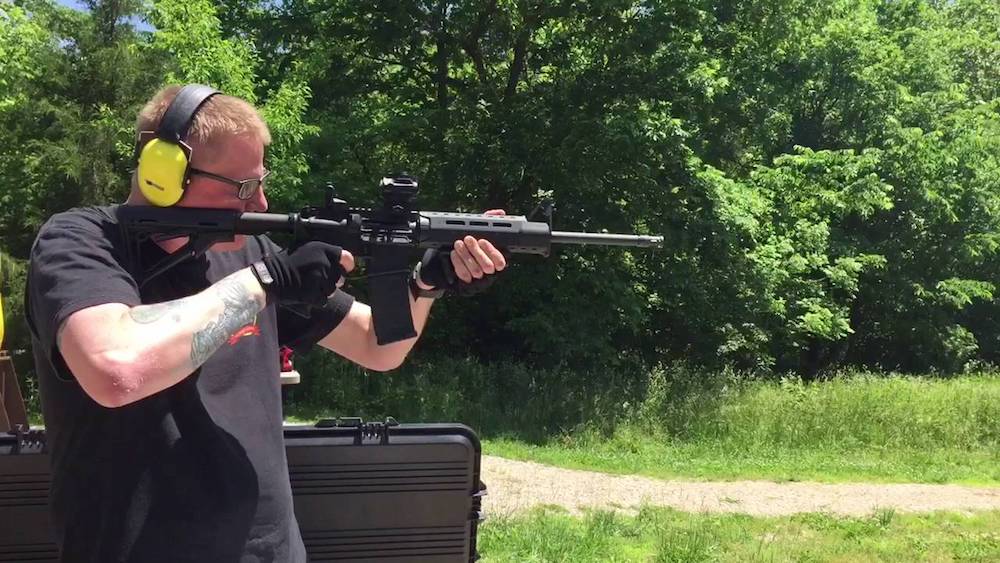 image of a man standing with his Ruger AR-556 for target shooting