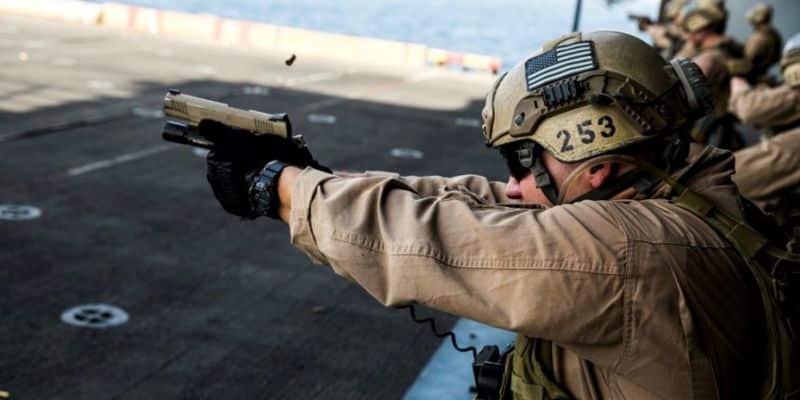 A US Marine shooting a 1911 semi automatic at the range 