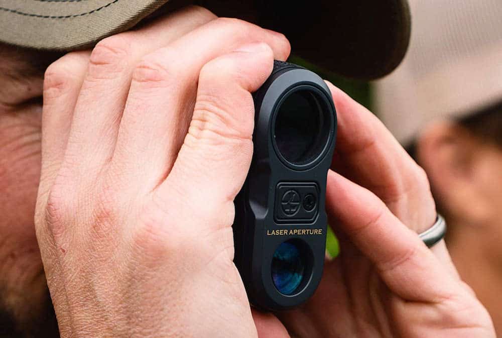 image of a man using rangefinder for bow hunting