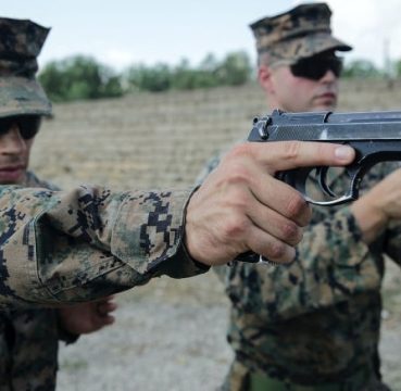 a picture of The Beretta M92FS held by a US Marine